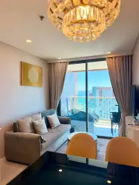 1 Bedroom Condo for Rent at Copacabana Beach Jomtien dining and living area with crystal chandelier and balcony view
