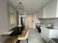 1 Bedroom Condo for Rent at Copacabana Beach Jomtien kitchenette with dining table, fridge and washing machine