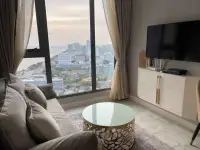 1 Bedroom Condo for Rent at Copacabana Beach Jomtien living room with sofa, TV cabinet and ocean view window