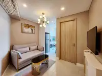 1 Bedroom Condo for Rent at Copacabana Beach Jomtien living room with sofa, chandelier, and wall-mounted TV