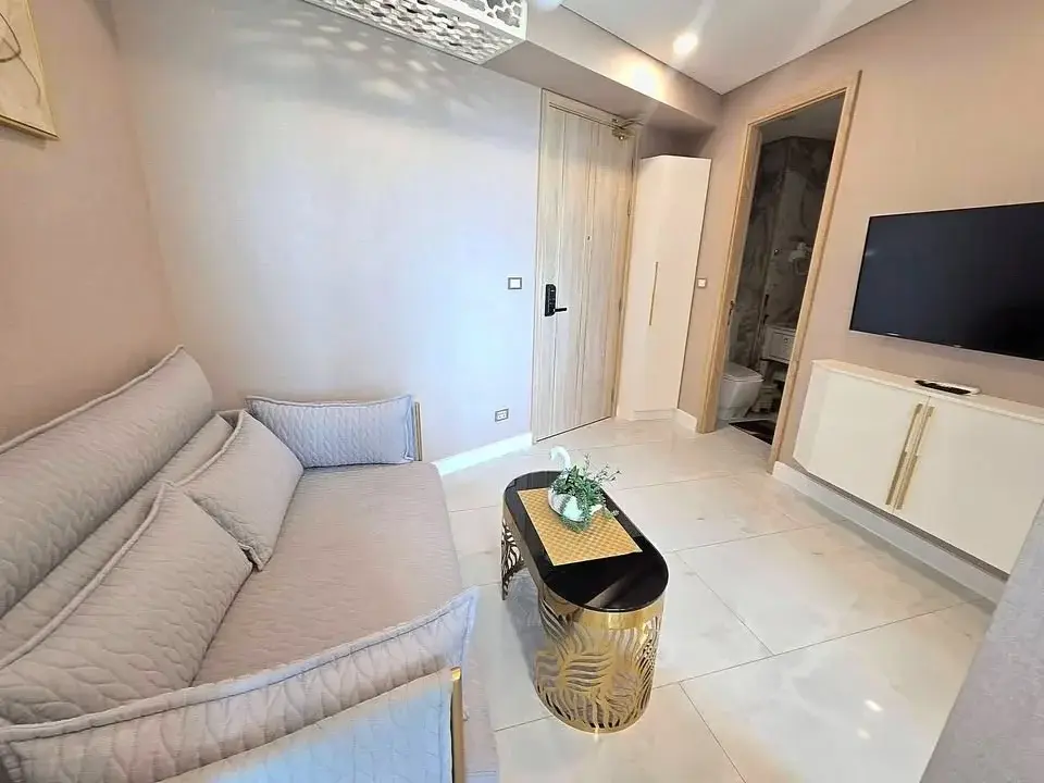 1 Bedroom Condo for Rent at Copacabana Beach Jomtien living room with gray sofa and gold coffee table