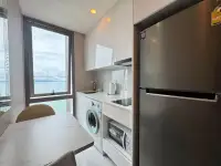 1 Bedroom Condo for Sale at Copacabana Beach Jomtien kitchen with ocean view, washer and dark refrigerator