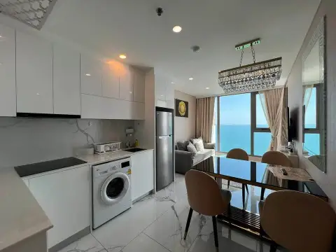 2 Bedroom Condo for Sale at Copacabana Beach Jomtien open-plan kitchen with marble floors and sea-view dining area