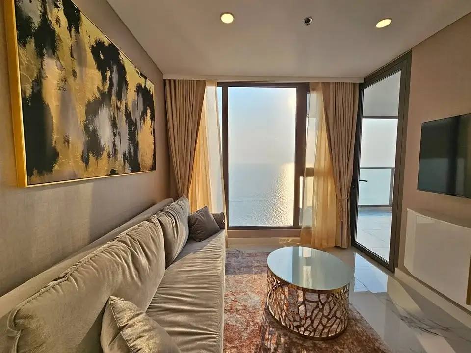 2 Bedroom Condo for Sale at Copacabana Beach Jomtien living room with sofa, gold accents and sea view