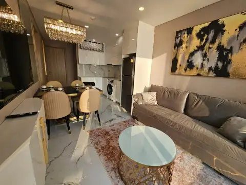 2 Bedroom Condo for Sale at Copacabana Beach Jomtien living room with gold artwork, dining table and kitchen