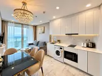 1 Bedroom Condo for Sale at Copacabana Beach Jomtien open-plan kitchen with marble countertops and ocean-view living area