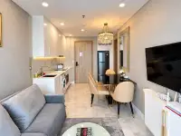 1 Bedroom Condo for Sale at Copacabana Beach Jomtien living room with gray sofa, dining table and compact kitchenette