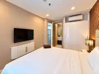 1 Bedroom Condo for Sale at Copacabana Beach Jomtien bedroom view toward en-suite bathroom and wall-mounted TV