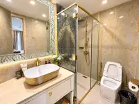 1 Bedroom Condo for Sale at Copacabana Beach Jomtien marble bathroom with glass shower, gold fixtures and vessel sink