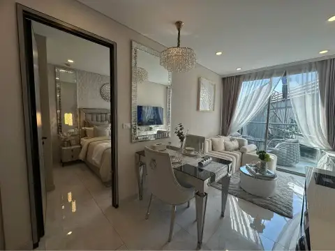 1 Bedroom Condo for Sale at Copacabana Coral Reef dining area with mirrored accents and view into bedroom