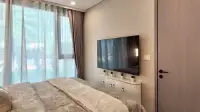 1 Bedroom Condo for Sale at Copacabana Coral Reef bedroom with wall-mounted TV and white cabinet storage
