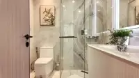 1 Bedroom Condo for Sale at Copacabana Coral Reef bathroom with glass-enclosed shower and marble tile walls
