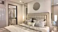 1 Bedroom Condo for Sale at Copacabana Coral Reef master bedroom with upholstered headboard and en-suite bathroom