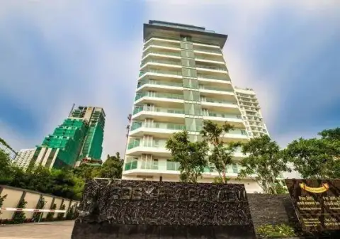 1 Bedroom Condo for Sale at Cosy Beach View building facade and entrance signage surrounded by greenery