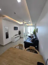 1 Bedroom Condo for Sale at Cosy Beach View hallway view of lounge, TV unit and dining table