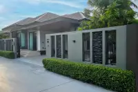 3 Bedroom House for Sale at Amarin House 2 front facade with stone-accented boundary wall, iron gate, and trimmed hedges