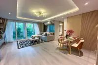 2 Bedroom Condo for Sale at Pristine Park 3 open-plan living and dining area with gold chandelier and floor-to-ceiling balcony doors