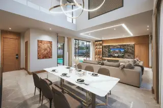 D Space Pattaya spacious open-plan living and dining area with high ceilings, modern furniture, and large windows.