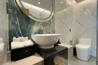 2 Bedroom Condo for Sale at Wyndham Jomtien Pattaya - bedroom with two beds, blue pillows, and large window.