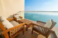 1 Bedroom Condo for Sale at Cetus Beachfront spacious balcony with teak wood furniture and panoramic ocean view