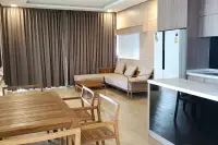 2 Bedroom Condo for Sale at Cetus Beachfront open-plan living and dining area with wooden furniture and kitchen island