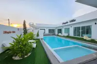 5 Bedroom House for Sale in Huai Yai outdoor pool with water slide and green garden at sunset