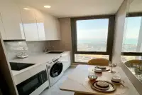 1 Bedroom Condo for Rent at Copacabana Beach Jomtien modern white kitchen with marble countertop dining area and sea view