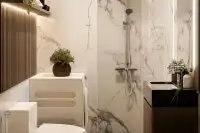 Studio Condo for Sale at Siam Oriental Beach: Bathroom with marble-patterned tiles, a shower, sink, and washing machine.
