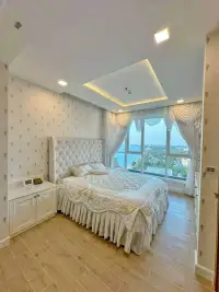 2 Bedroom Condo for Sale at Del Mare bedroom with tufted headboard, bedside cabinet and panoramic sea view