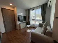 2 Bedroom Condo for Rent at Dormy Residences Sriracha living room with gray sofa and window view of hills