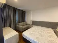 2 Bedroom Condo for Rent at Dormy Residences Sriracha bedroom with mattress, sofa and curtained window
