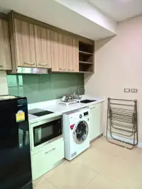 1 Bedroom Condo for Rent at Dusit Grand Condo View kitchenette with washing machine, microwave, and fridge
