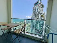1 Bedroom Condo for Sale at Dusit Grand Condo View balcony with seating and high-rise sea view