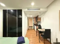 1 Bedroom Condo for Rent at Dusit Grand Park 1 open-plan layout with wardrobe, dining table, and kitchen hallway