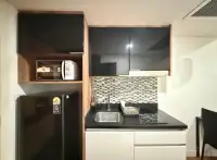 1 Bedroom Condo for Rent at Dusit Grand Park 1 kitchenette with black countertop, sink, and microwave