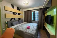 2 Bedroom Condo for Sale at Dusit Grand Park 1 bedroom with wood-slat headboard, gray bedding, and wall-mounted TV