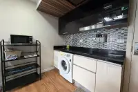 2 Bedroom Condo for Sale at Dusit Grand Park 1 kitchenette with washing machine, black countertop, and microwave rack