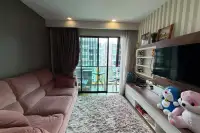 2 Bedroom Condo for Sale at Dusit Grand Park 1 living room with pink sofa, TV unit, and balcony city view