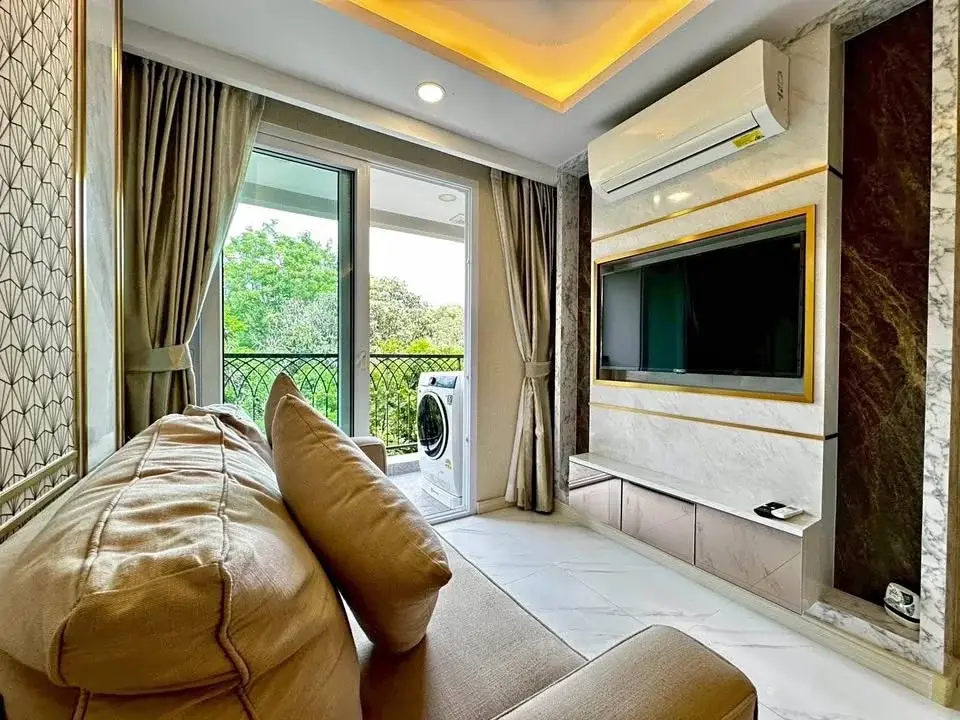 1 Bedroom Condo for Rent at Dusit Grand Park 2 living room with marble TV wall and balcony access