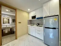1 Bedroom Condo for Rent at Dusit Grand Park 2 kitchen with fridge, microwave and mosaic tile backsplash