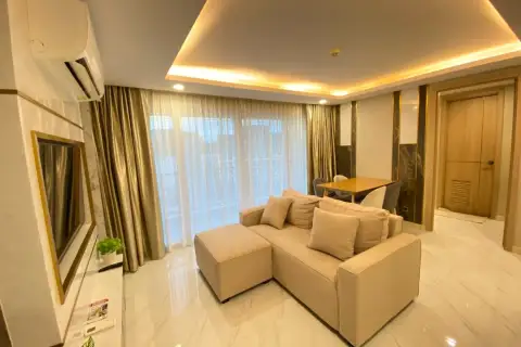 2 Bedroom Condo for Rent at Dusit Grand Park 2 open living area with sectional sofa, balcony view, and dining nook