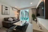1 Bedroom Condo for Sale at City Center Residence living room with grey sofa marble coffee table and pool-view balcony