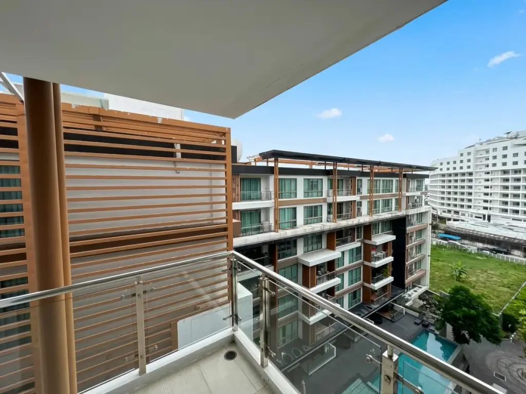 2 Bedroom Condo for Sale at The Urban Pattaya balcony view with wood slat privacy screen and city buildings