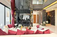 5 Bedroom House for Sale at Harmony Hills Villas Pattaya grand living room with double-height ceiling and black marble wall.