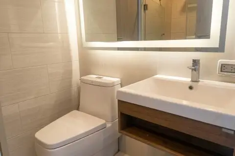 1 Bedroom Condo for Sale at Aeras modern bathroom with illuminated mirror and wooden vanity
