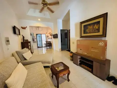 2 Bedroom House for Rent at Eakmongkol 4 living room with sectional sofa, TV console and kitchen view