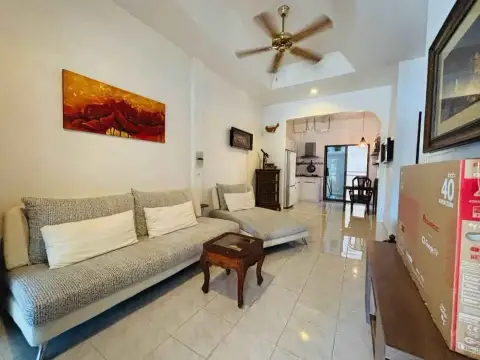 2 Bedroom House for Rent at Eakmongkol 4 living room with ceiling fan, sofa and abstract wall art