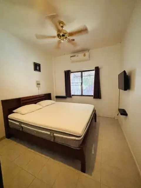2 Bedroom House for Rent at Eakmongkol 4 bedroom with double bed, ceiling fan and wall-mounted TV