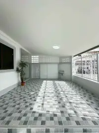 2 Bedroom Townhouse for Rent at Eakmongkol 4 spacious covered carport with potted plant and tiled floor