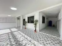 2 Bedroom Townhouse for Rent at Eakmongkol 4 wide carport area with windows, plants, and storage tank
